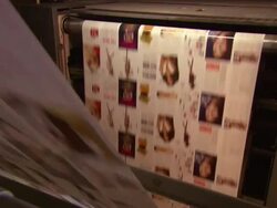 Medium Close Up static - Long sheets of printed paper run through a printing press /  Wisconsin, United States Stock Footage