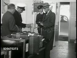 1941: STOCKHOLM, SWEDEN: HA WS Waterfront w/ docked tour boats & Grand Hotel (R). WS People walking outside front entrance og Grand Hotel. INT Grand Hotel dining room w/ waiters serving people. Business men having beer, food, conversation at table. Instructional Video