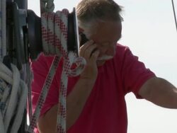 MS Pensioner talking on his cell phone on his sailboat / Wismar, Mecklenburg-Vorpommern, Germany Stock Footage