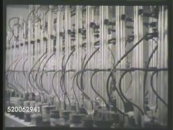 1935: RESEARCH LABORATORY: * VS Scientists in lab w/ air tubes, testing corrosive effects of various motor cooling solutions on metal strips. MCU Iron, copper, solder, brass & aluminum metal pieces in jars w/ bubbling liquids (air). Corrosion Instructional Video