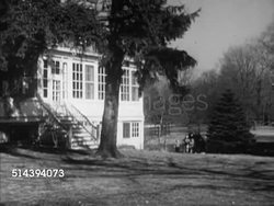 1953: TOLSTOY FARM: WS Woody station wagon turning into property drive, driving long driveway, stopping by house, adults supervising children playing in front yard FG, Westbrook Van Voorhis in coat stepping out of car, walking to, opening house door. Instructional Video