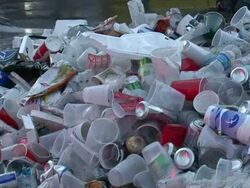 Medium Shot High Angle - Trash pile in street; aluminum cans, plastic cups and bottles, red solo cups / New Orleans Louisiana Stock Footage