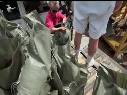 Wardens keep watch as inmate trustees from St. Martin Parish Correctional Center make sand bags to protect residents against flooding in Stephensville, Louisiana. Instructional Video
