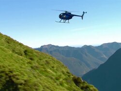 AIR TO AIR, Helicopter flying above mountain river, Fiordland National Park, New Zealand Stock Footage