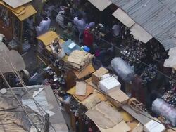 MS Street with men walking and stands full of shoes / Lagos, Nigeria Stock Footage