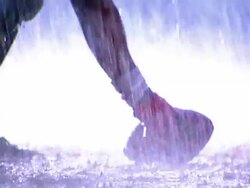 OVEREXPOSED close up PAN football player snaps ball into play, second player runs with ball in rain Stock Footage
