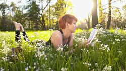 SLO MO Woman reading a book in the nature Stock Footage