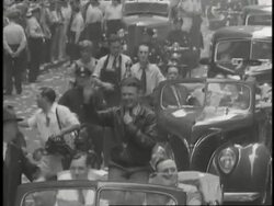 Crowds cheer for aviator Douglas Corrigan in a huge parade. News Clip