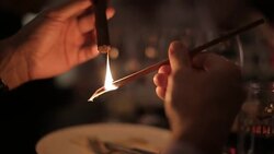 Lighting a cigar with cedar Stock Footage