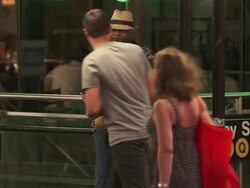 A man plays the sax in front of a subway in Time Square.  People walk by. Stock Footage