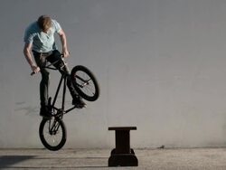 Male on bicycle performing jump trick Stock Footage
