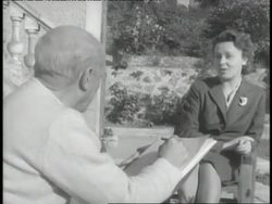 Pablo Picasso talks with a model as he sketches her. News Clip