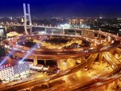 Time lapse high angle wide shot traffic on Nanpu Bridge spiral at night / Shanghai Stock Footage