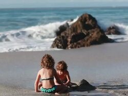 MS Boy and girl build sandcastle on beach with waves and ocean  / Montezuma, Puntarenas, Costa Rica Stock Footage