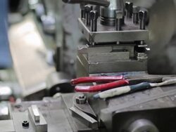Worker on a machine in a factory,Tilt up Stock Footage