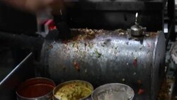 An egg omelette being cooking in a pan at a food stall in Old Delhi, late in night Stock Footage