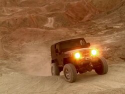 WS ZO ZI Two rock crawlers with their all terrain vehicles moving in mountainous desert area at dusk / Salton City, California, USA  Stock Footage