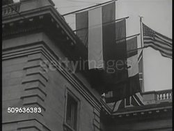 1921/1922: INTERNATIONAL CONFERENCE ON NAVAL LIMITATION: EXT Building w/ flags hanging. Unidentified male, Henry Cabot Lodge (C) & Elihu Root. WS President Warren G. Harding (1865-1923) w/ wife Florence standing on busy sidewalk. Instructional Video