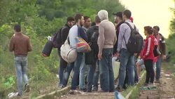 European Migration Crisis: Refugees Walk Along Train Tracks in Roszke News Clip