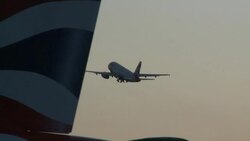 British Airways jet takes off into dusk skyline Stock Footage