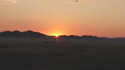 The sun shines over a ridge in the Namib Desert. Stock Footage