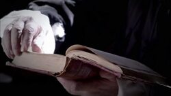 Nostradamus reads a book at his desk. Stock Footage