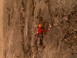 AERIAL, Rock climber on rock face, Fiordland National Park, New Zealand  Stock Footage