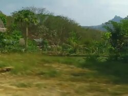 MS POV SLO MO Shot of primitive wooden houses and small lake surrounded by green vegetation / Road from Luang Prabang to Nong Khio, Luang Prabang, Laos Stock Footage