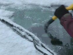 CU Snow being removed from car  / Saarburg, Rhineland-Palatinate, Germany Stock Footage