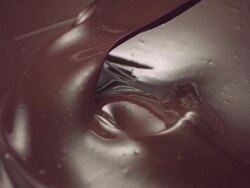 CU SLO MO Wooden spoon stirring liquid chocolate Stock Footage