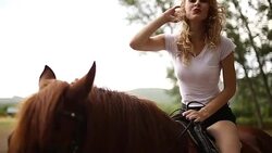 Beautiful woman riding a horse Stock Footage