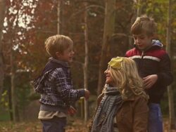 Mother and children playing with autumn leaves Stock Footage