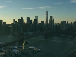 Aerial view of lower Manhattan and Bridges from Brooklyn and East River NYC snow Stock Footage