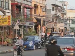 WS traffic on street and shopfronts / Vientiane, Laos Stock Footage