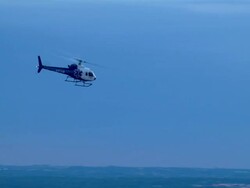 Life Flight emergency medical helicopter ascending over a city into an evening sky Stock Footage