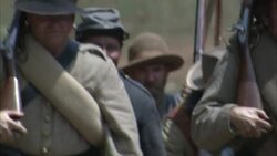 Confederate infantrymen march across a field during the Civil War. Stock Footage