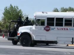 April 7 2009 WS Mexican police cars entering military base, Juarez, Chihuahua, Mexico, AUDIO Stock Footage