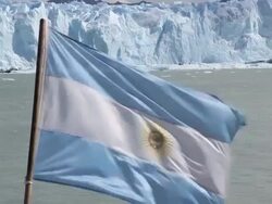 Argentinian flag in front of Perito Moreno Stock Footage