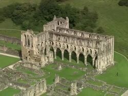 Aerial over ruins of Rievaulx Abbey / Rievaulx, North Yorkshire, England Stock Footage