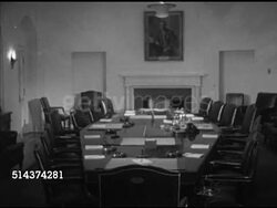 1952: WHITE HOUSE CABINET ROOM: CU Wooden door opening REVEALS conference table w/ fireplace & portrait painting of former President Woodrow Wilson hanging above mantle, PAN Table set w/ pads of paper, ashtrays, pens, desk pens, telephone, blotters. Instructional Video