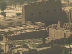 Long Shot, pan-left tracking-right zoom-out - A ruinous city faces the Nile River in Egypt Stock Footage