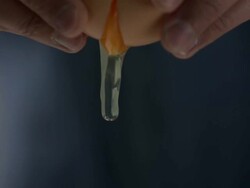 High speed Hands breaking egg, white and yolk spill out Stock Footage