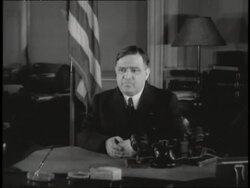 Fiorello LaGuardia, the Mayor of New York City, sits at the desk in his office. News Clip