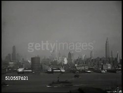 1950: U.S. FOOD AID TO YUGOSLAVIA: CU Newspapers '...Aid to Yugoslavia, Truman Asks to Aid Tito, To Feed Yugos.' WS New York Harbor, skyline. LA MS Ship in dock, loading supplies. CU Ship name 'Makedonija.' WS Packages lowering onto deck. Instructional Video