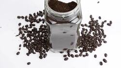 close-up panning: coffee beans and instant in a clear bottle Stock Footage