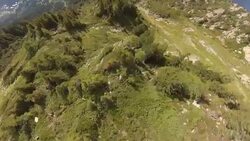 POV wingsuit flying over cliffs and alpine forests Stock Footage