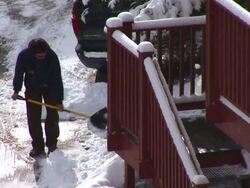 MS Shot of man shovels snow at Colorado Rockies in winter storm / Colorado, United States Stock Footage