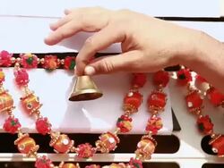 Close-up of a hand of a truck driver ringing bell hanging on his truck, Ballabgarh, Haryana, India Stock Footage