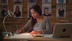 DS Asian woman working in busy startup office at night Stock Footage