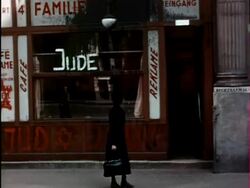 1938 medium shot pan storefronts of businesses w/Anti-Semitic graffiti, Star of David / Vienna, Austria Stock Footage